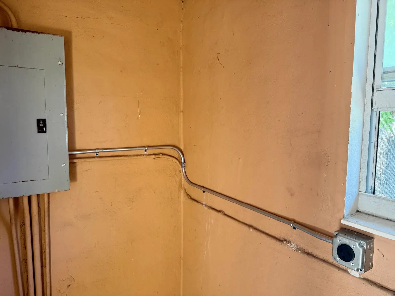 Exterior electrical panel and conduit installation