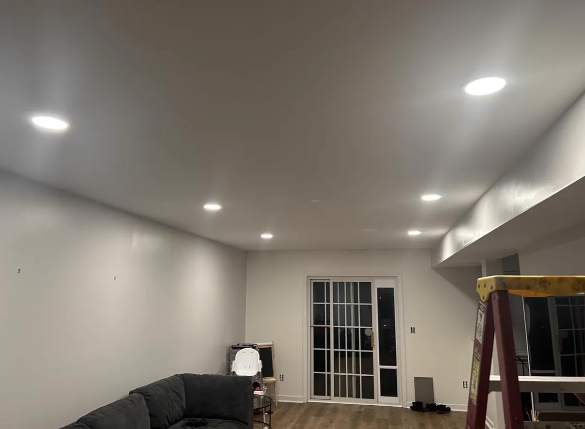 Recessed pot lights installed in a living room ceiling